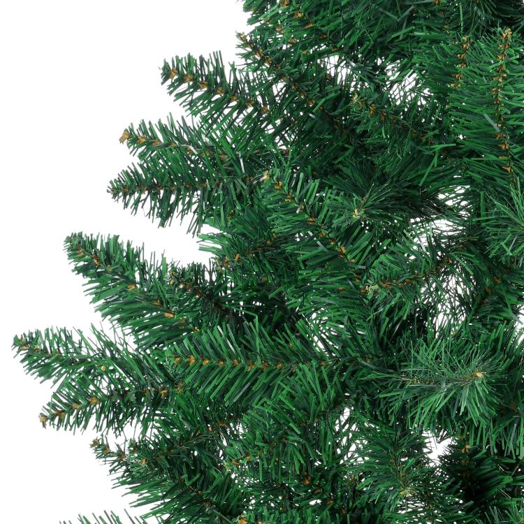 Artificial half Christmas tree branch and needles close-up, dense green foliage