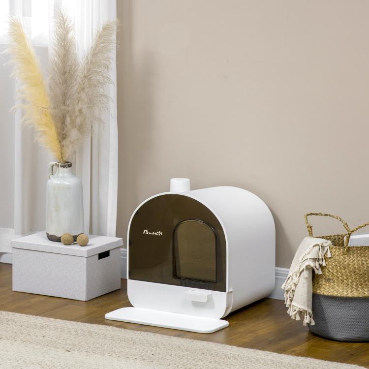 White enclosed cat litter box with brown front window and front pull tray on floor