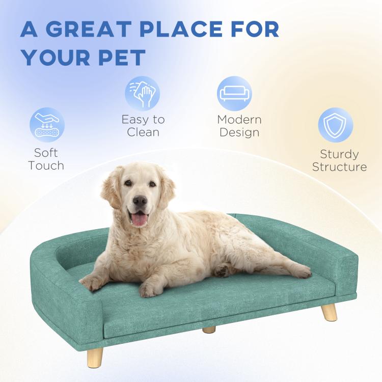 Green pet sofa bed with cushioned surface and wooden legs for everyday rest