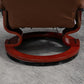 Brown leather recliner footrest and wrapped wood base, view of underside support