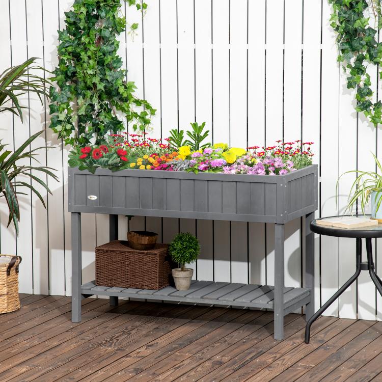 Dark gray elevated planter with flower bed top and lower rack shelf for pots