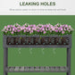 Dark gray raised planter bed with drainage holes along the bottom of the planter