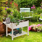 White wooden raised planter bed with open storage shelf and wheeled stand