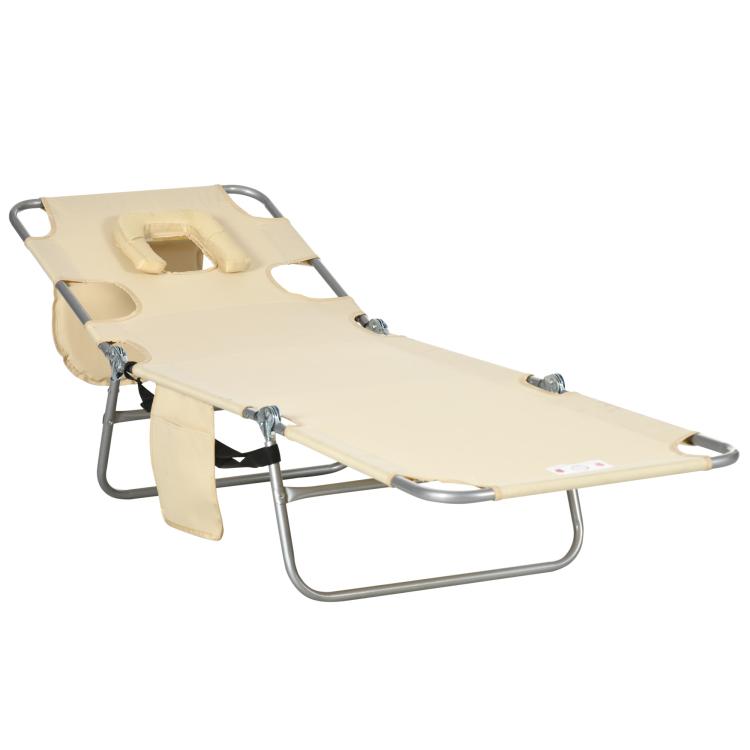 Beige adjustable tanning chaise lounge with face-hole pillow and metal base