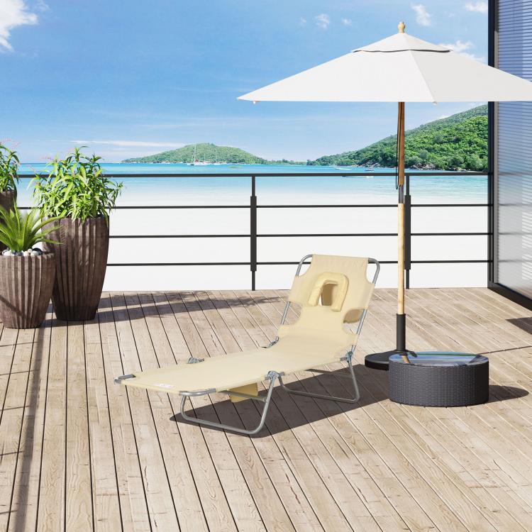 Beige tanning chaise lounge with face pillow and folding steel legs