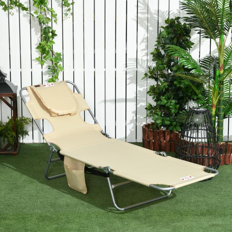 Beige face-hole tanning chair with padded head pillow and folding steel frame