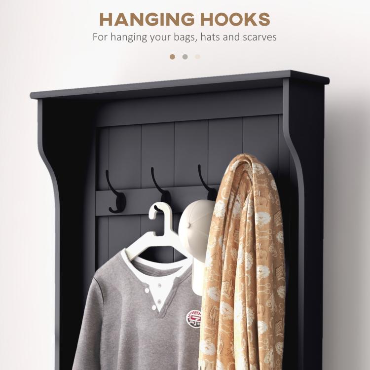 Black entryway hall tree close-up of hanging hooks with coats on display