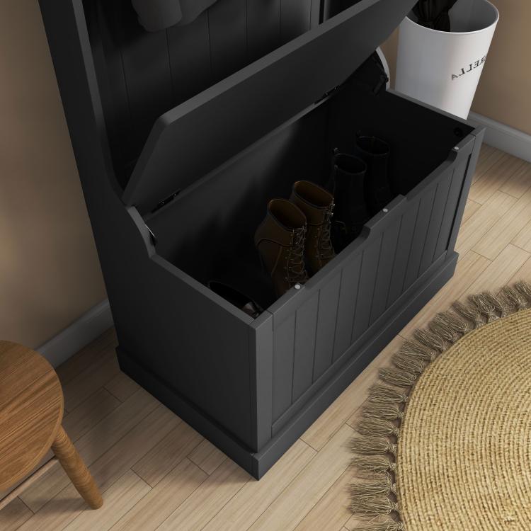 Black storage bench compartment with boots inside, hinged top open