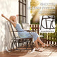 Outdoor glider rocking chair with light beige sling back and seat, dark steel frame