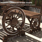 Brown wagon-wheel dining table with carriage frame and slatted tabletop