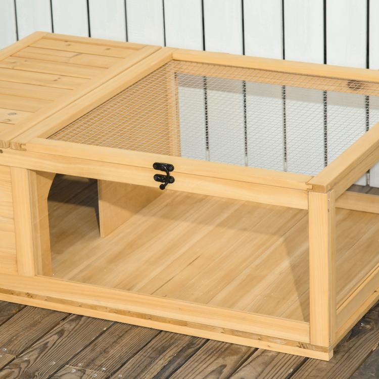 Close-up of wooden reptile enclosure with mesh top and black latch on lid
