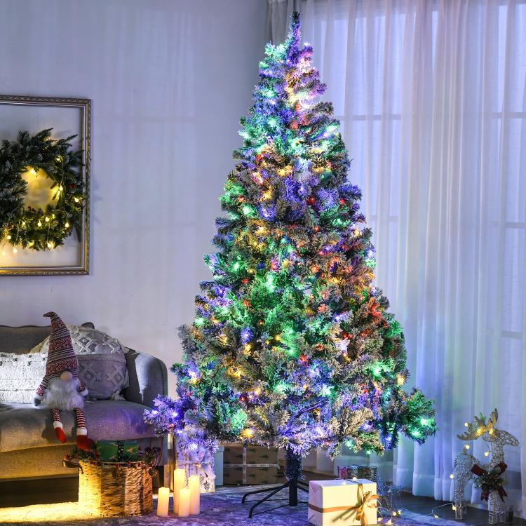 Artificial Christmas tree with frosted branches and colorful LED lights, fully lit
