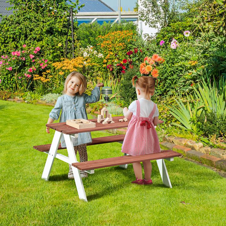 Kids wooden picnic table set with two benches and brown tabletop, used outdoors on grass