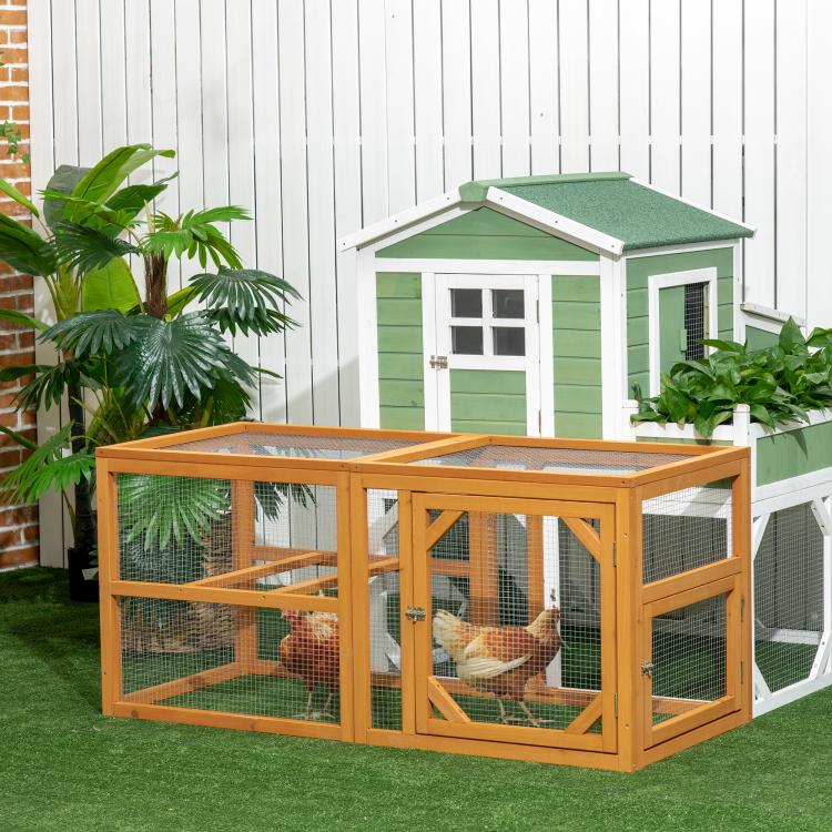 Wooden chicken run add-on with wire mesh sides and roof panel, hens visible inside