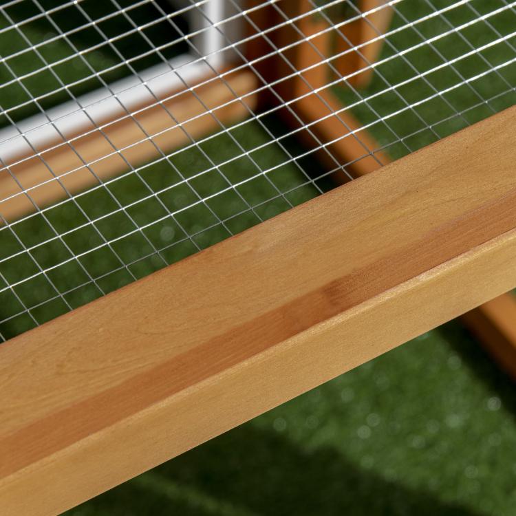 Close-up of wooden beam and wire mesh grid inside chicken run add-on