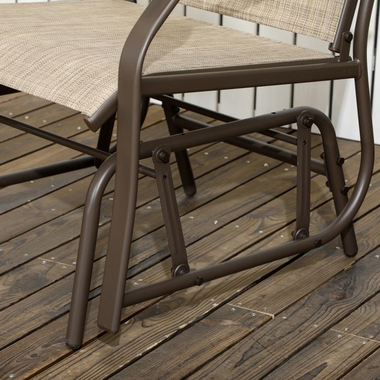 Outdoor rocking bistro chair with dark brown metal frame and tan sling seat