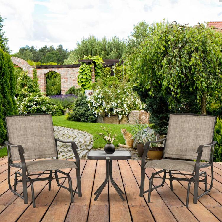 Patio bistro set with two beige sling rocking chairs and a round glass-top coffee table