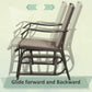 Rocking patio chair with dark metal frame and beige sling seat, side view