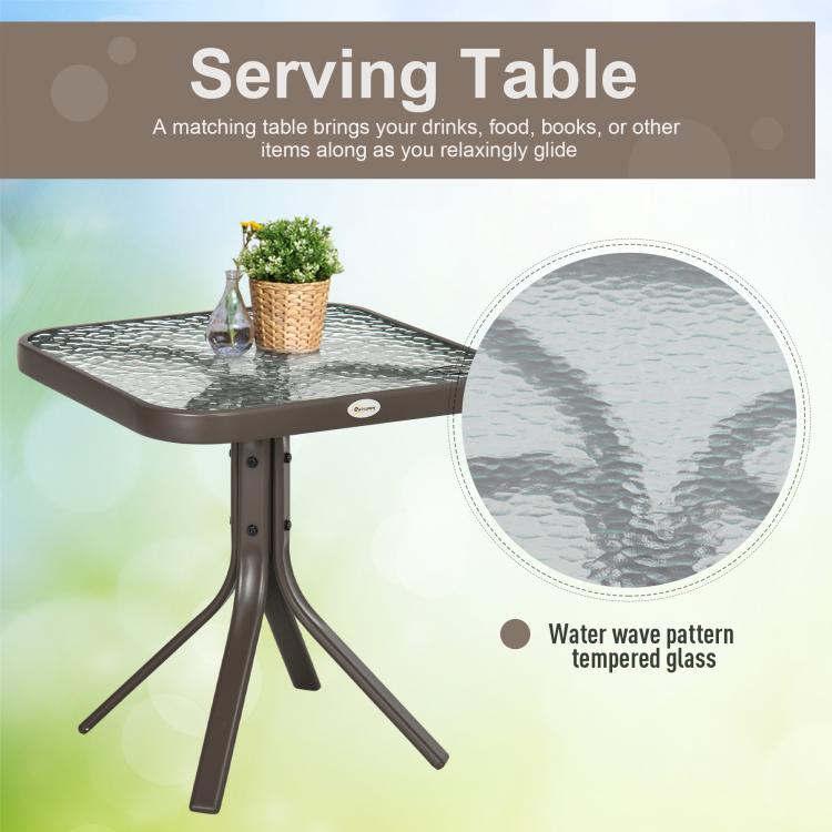 Outdoor serving table with textured tempered glass top and dark pedestal tripod legs