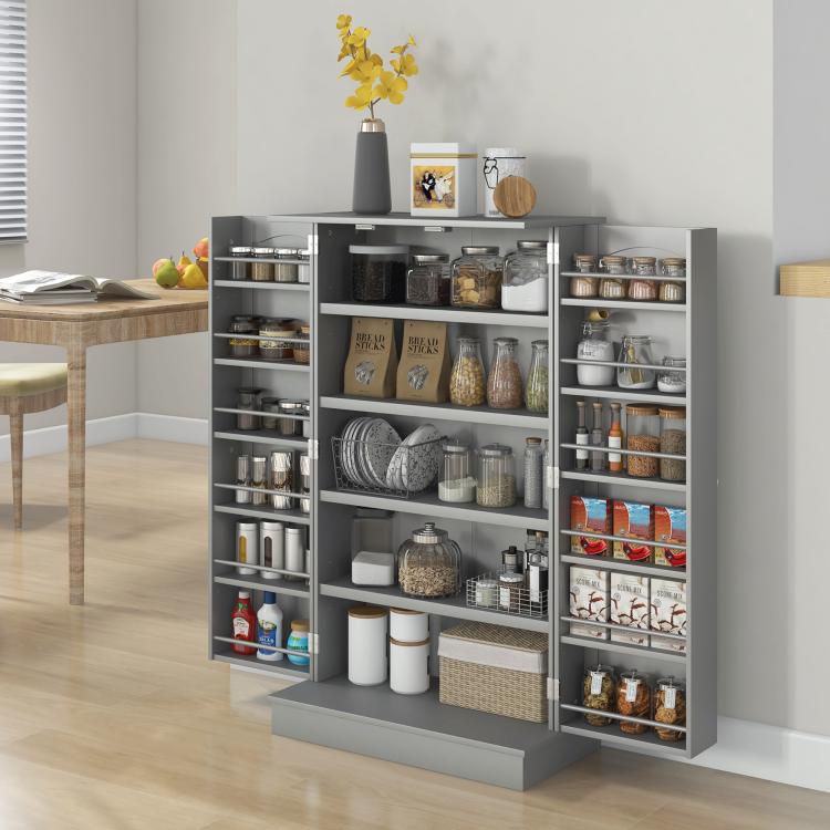 Gray kitchen pantry cabinet with open doors and tiered shelves for jars and tins