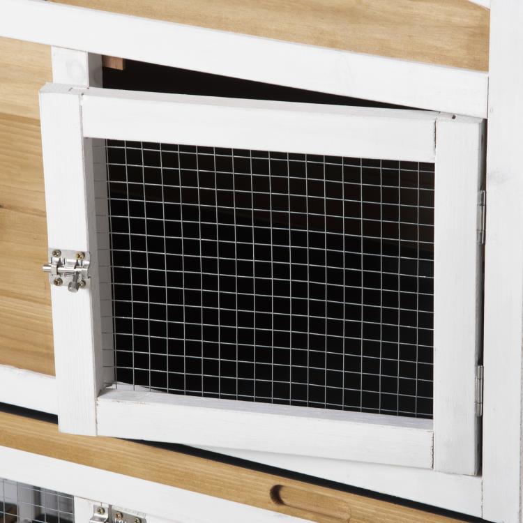 Close-up of rabbit hutch door with white frame, wire mesh panel, and metal latch