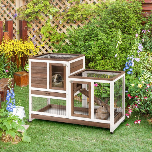 Outdoor wooden rabbit hutch with wire enclosure, ramp, and raised top platform on wheels