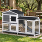 Outdoor rabbit hutch with two levels, black roofs, wire mesh windows, and ramp