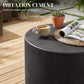 Concrete-look dark gray round side table with coffee cup on top
