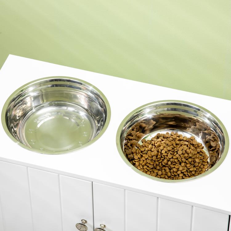 Close-up of two stainless steel dog bowls on a white raised feeding stand