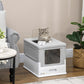 Gray and white enclosed cat litter box on floor with front window opening and cat