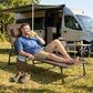 Brown folding chaise lounge with padded seat and back, side pocket, on steel frame