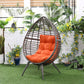 Orange patio egg chair with dark wicker shell and thick tufted seat cushion