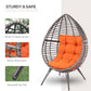 Egg chair with orange seat cushion; dark metal frame and PE wicker basket shell