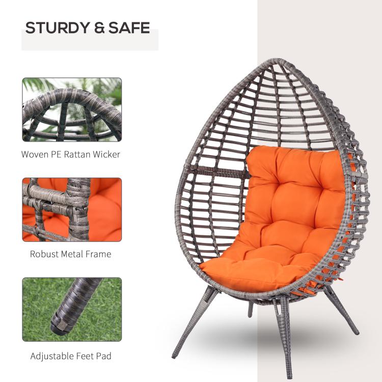 Egg chair with orange seat cushion; dark metal frame and PE wicker basket shell