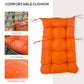Thick orange cushion with tufted padding and fabric ties for an egg chair