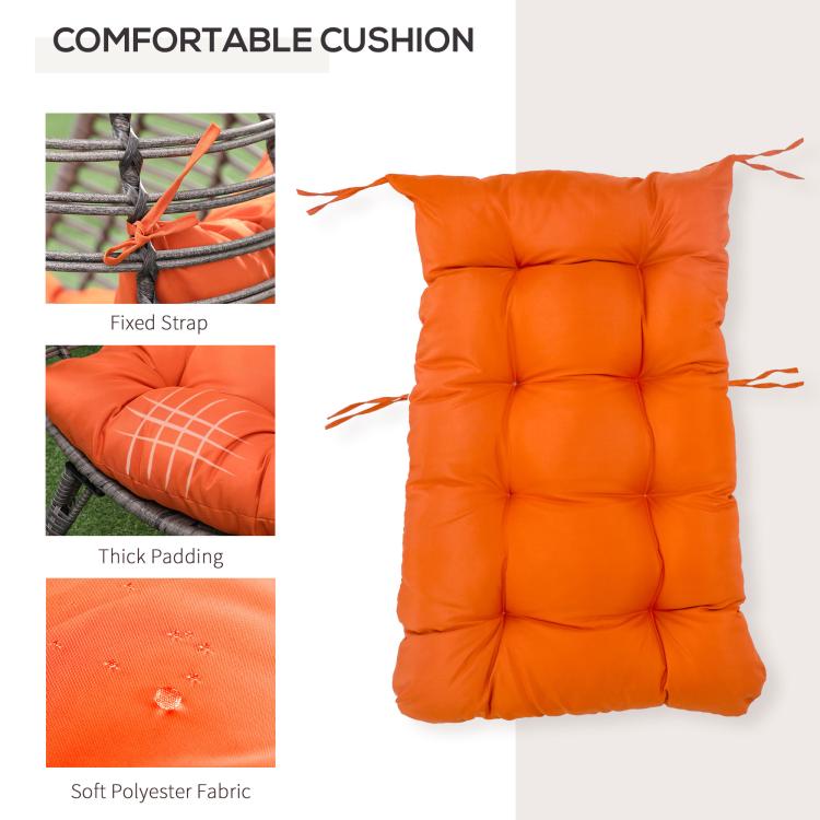 Thick orange cushion with tufted padding and fabric ties for an egg chair
