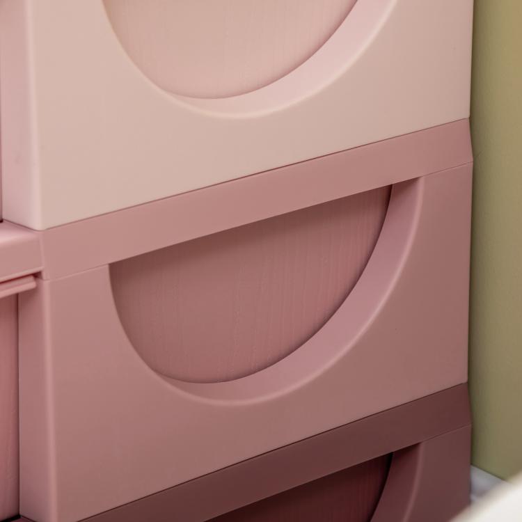 Pink drawer bin front with curved handle cutouts on a 3-tier organizer