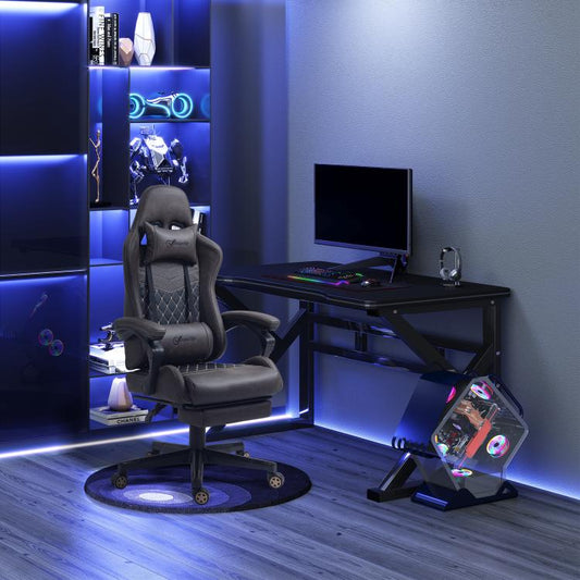Dark brown racing gaming chair with extended footrest and tall padded back