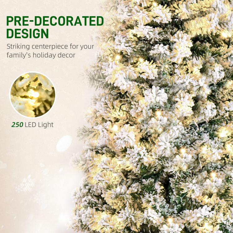 Close-up of snow-flocked artificial Christmas tree branches with warm pre-lit LED lights