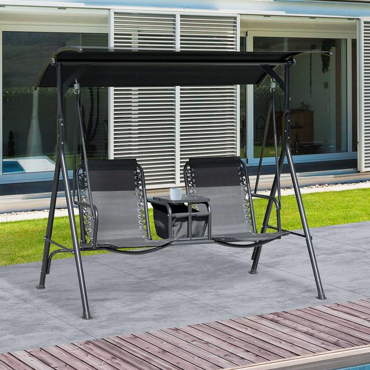 Black 2-person porch swing with canopy and two sling seats on an outdoor patio