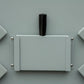 Grey folding tabletop gas BBQ grill with closed lid and side panels