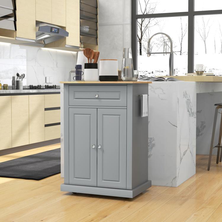 Grey kitchen island cart with drawer and cabinet doors beside countertop, caster base