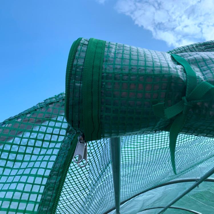 Green tunnel hoop greenhouse end cap close-up with PE cover straps