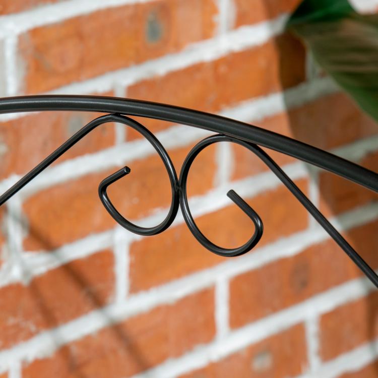 Black steel garden fence panel with curved vine border and arched scroll detail