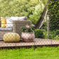 Steel garden fence panels with arched tops and diamond mesh in yard bed