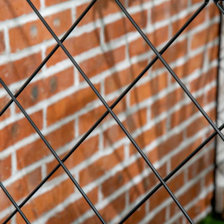 Diamond wire mesh section on a black steel garden fence frame