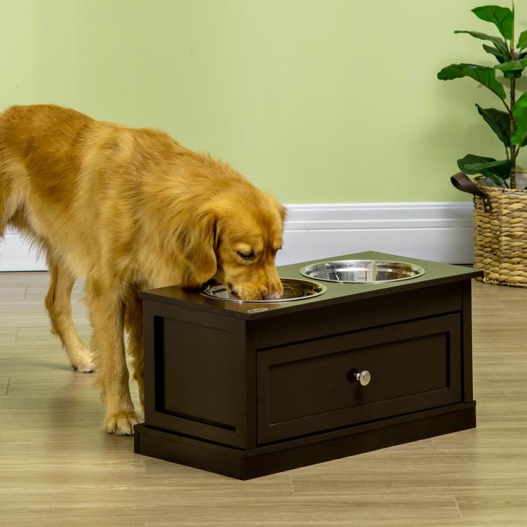 Brown raised dog bowl stand with two stainless steel bowls, with a dog at it