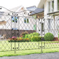 Black steel fence panel with diamond lattice and decorative scrollwork, set in yard