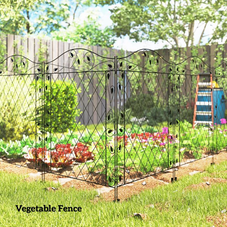 Black steel garden fence with diamond lattice, decorative curls, and ground stakes