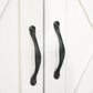 White cabinet door handle with curved black metal pull
